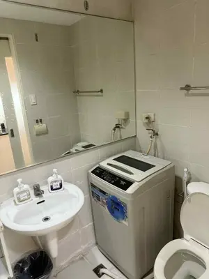 a bathroom with a sink and a toilet and a mirror at Sea Residences Condotel With Balcony, by Rose in Manila
