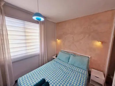a small bedroom with a bed and a window at Vibrant Spacious Condo near SM East NU Medical City in Manila