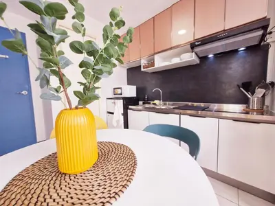 a yellow vase sitting on a table in a kitchen at Vibrant Spacious Condo near SM East NU Medical City in Manila