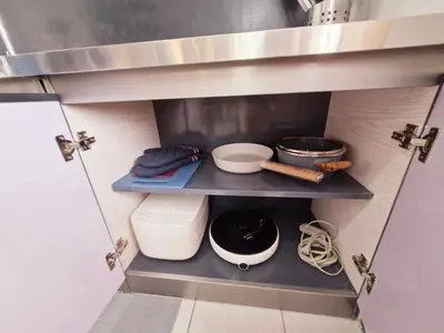 a kitchen with a shelf with some food on it at Vibrant Spacious Condo near SM East NU Medical City in Manila