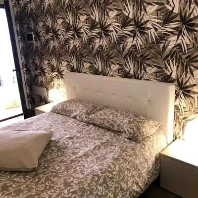 a bedroom with a bed with a flower patterned wall at Sunvalley B&b in Manila