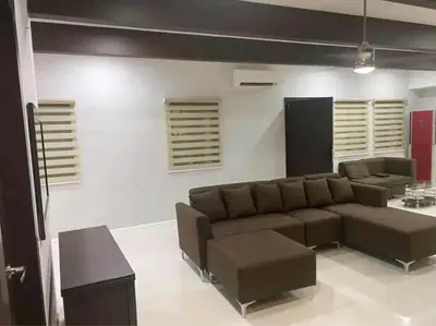 a living room with a couch and a table at Sunvalley B&b in Manila