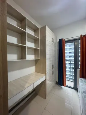a bedroom with wooden shelves and a window at FAME RESIDENCES CONDO-TEL Near EDSA Shang in Manila