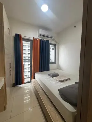 a bedroom with a large bed and a window at FAME RESIDENCES CONDO-TEL Near EDSA Shang in Manila