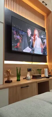 a bedroom with a flat screen tv on a wall at Eu & El Condo in Manila
