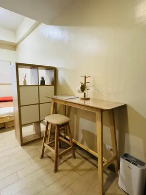 a wooden table with a stool and a cross on it at Maple Grove Yasuragi Stay in General Trias