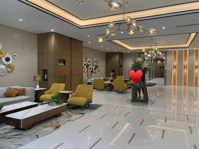a lobby of a hotel with a red heart on a table at JUANderful Home at Park McKinley West in Manila