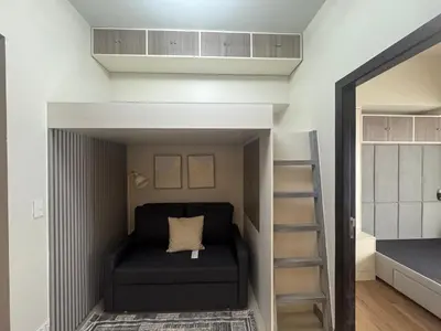a bed in a room with a bunk bed at JUANderful Home at Park McKinley West in Manila