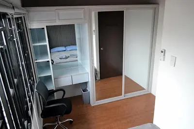 a room with a desk and a chair and a bedroom at Auntie's in Tanza
