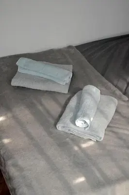 a pair of towels sitting on top of a bed at Auntie's in Tanza