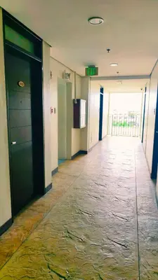 an empty hallway of an office building with a door at Cozy Corner at Paseo Verde with Free On-Site Private Parking in Manila