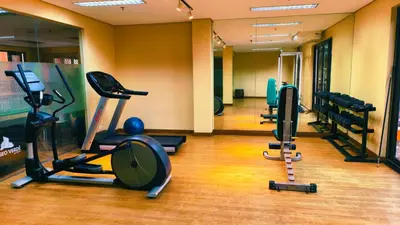 a gym with several treadmills and cardio machines at Cozy Corner at Paseo Verde with Free On-Site Private Parking in Manila