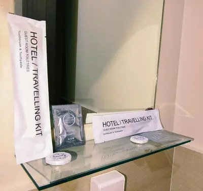 a glass shelf with a sign and a box on it at Cozy Corner at Paseo Verde with Free On-Site Private Parking in Manila