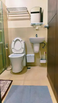 a bathroom with a toilet and a sink at Cozy Corner at Paseo Verde with Free On-Site Private Parking in Manila
