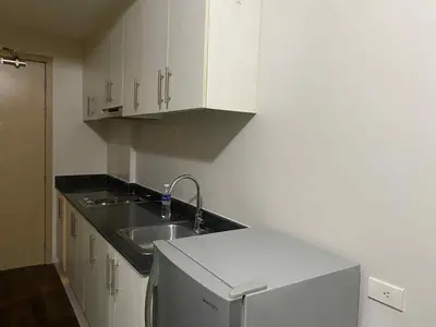 a kitchen with a sink and a counter top at Sea Residences Tower F in Manila