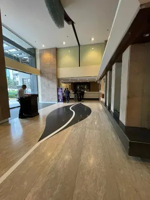 an empty lobby of a building with people walking around at Antel Spa Residences 10E in Manila