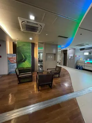 a lobby with two chairs and a large screen at Antel Spa Residences 10E in Manila