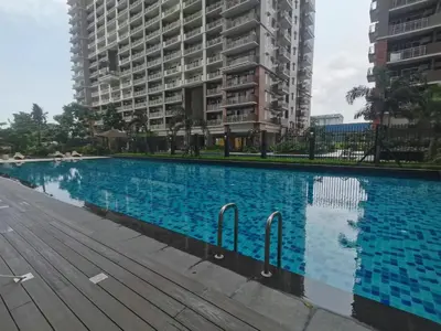a large swimming pool in front of some buildings at fairlane residences in Manila