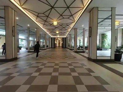 a person walking down a hallway in a building at fairlane residences in Manila