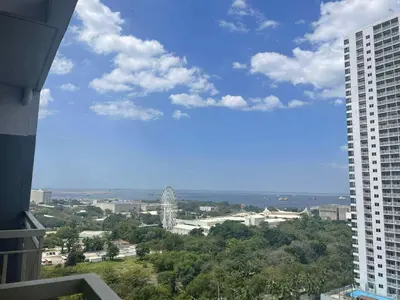 a view of a city from the balcony of a building at Modern Comfort in Pasay with Pool in Manila