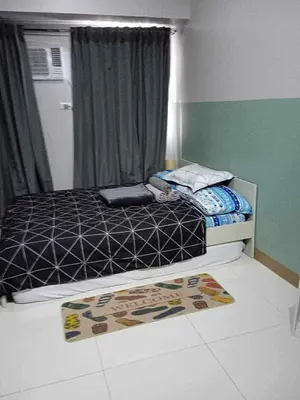 a bedroom with a bed and a window at Modern Comfort in Pasay with Pool in Manila