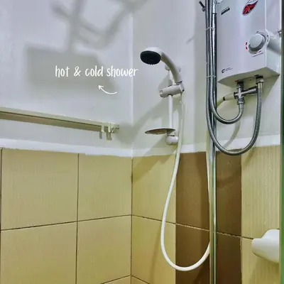 a shower in a bathroom with a hot and cold shower at JAZZ staycation in Manila