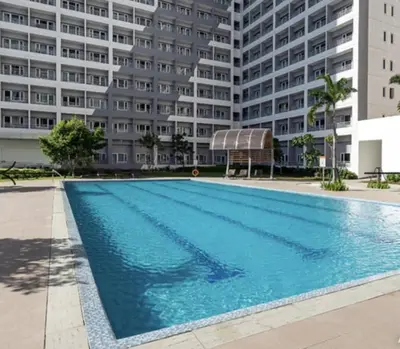 a swimming pool in front of a large building at JAZZ staycation in Manila