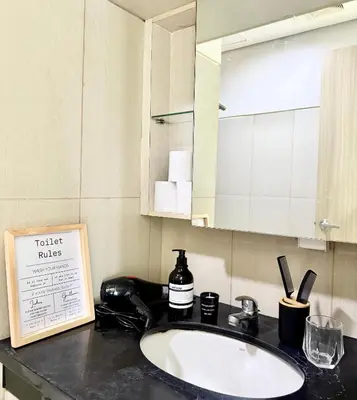 a bathroom counter with a sink and a mirror at COAST518 Pasay in Manila