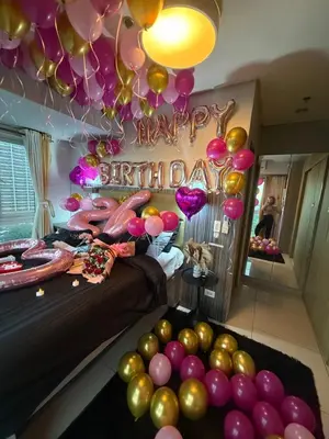 a room with balloons and a bed with a happy birthday sign at COAST518 Pasay in Manila