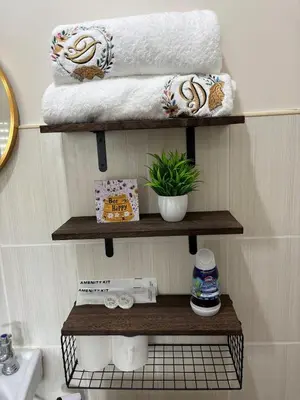 a bathroom with wooden shelves with towels and a sink at Dainty Den LF508 - Comfy & Chic Home beside Enchanted Kingdom in Santa Rosa