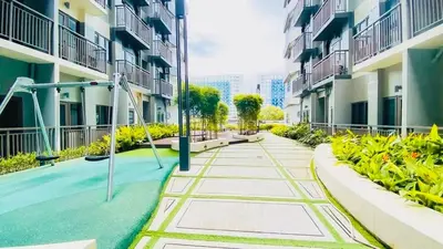 a walkway between two apartment buildings with a playground at S Residences Tower 2, 1 Bedroom in Manila