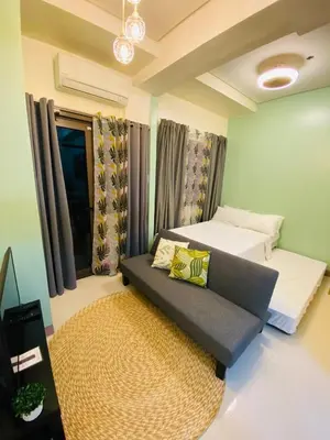 a small room with a couch and a bed at S Residences Tower 2, 1 Bedroom in Manila