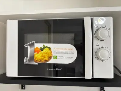 a microwave with a picture of food in it at Dainty Den LS217- Chic & Relaxing Stay Near Enchanted Kingdom in Santa Rosa