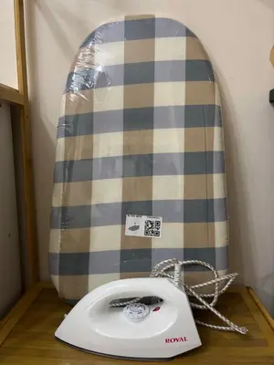 a white phone sitting on a table with a surfboard at Dainty Den LS217- Chic & Relaxing Stay Near Enchanted Kingdom in Santa Rosa