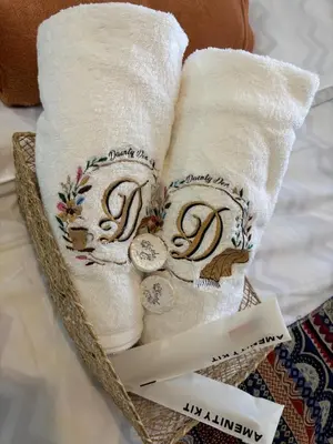two towels in a basket with a price tag at Dainty Den LS217- Chic & Relaxing Stay Near Enchanted Kingdom in Santa Rosa