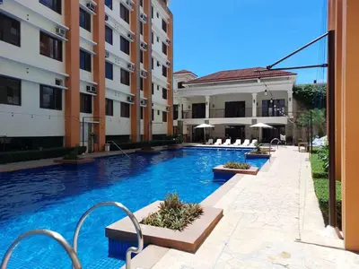 a swimming pool in front of some buildings at The Stayhaus by Dan & Steph in Manila