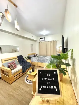 a room with a bed and a sign that says the stays by dam and spear at The Stayhaus by Dan & Steph in Manila