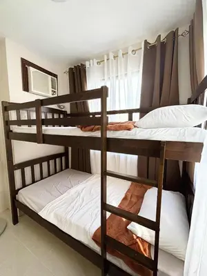 a couple of bunk beds in a room at Dainty Den Renovation in Macabling