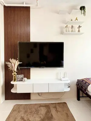 a living room with a flat screen tv on a wall at Dainty Den Renovation in Macabling