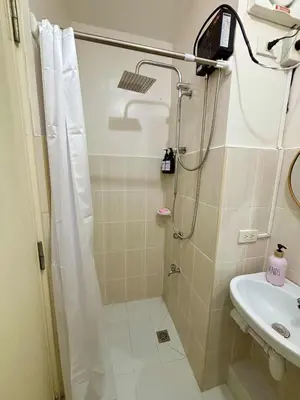 a bathroom with a shower and a sink at Dainty Den Renovation in Macabling