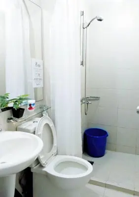 a bathroom with a toilet and a sink and a shower at Azure Paris Hilton Resort and hotel 1 bedroom for 4pax in Manila