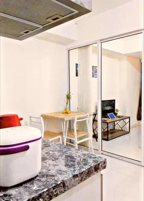 a living room with a table and a dining room at Azure Paris Hilton Resort and hotel 1 bedroom for 4pax in Manila