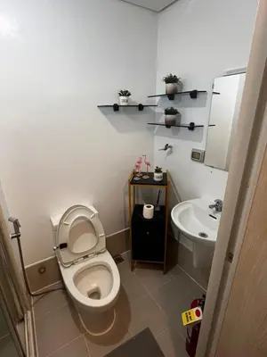 a bathroom with a toilet and a sink at Light Lux in Manila