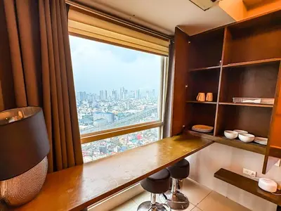 a room with a desk and a large window at City View Unit near Makati CBD in Manila