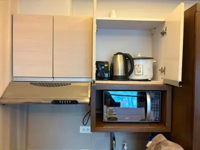 a kitchen with a microwave and a coffee maker at City View Unit near Makati CBD in Manila