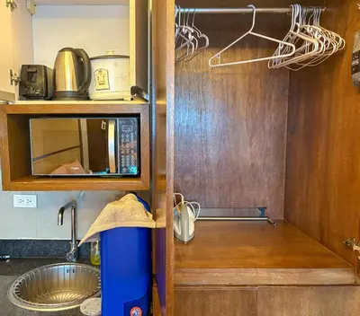 a kitchen with a sink and a microwave at City View Unit near Makati CBD in Manila