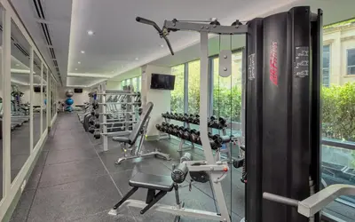 a gym with treadmills and machines in a building at Belmont Hotel Manila near NAIA Terminal 3 MNL in Manila