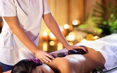 a woman getting a massage from a therapist at Belmont Hotel Manila near NAIA Terminal 3 MNL in Manila