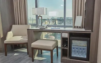 a hotel room with a desk and chair and a window at Belmont Hotel Manila near NAIA Terminal 3 MNL in Manila