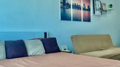 a bed and a chair in a room at High End Penthouse Makati CBD in Manila